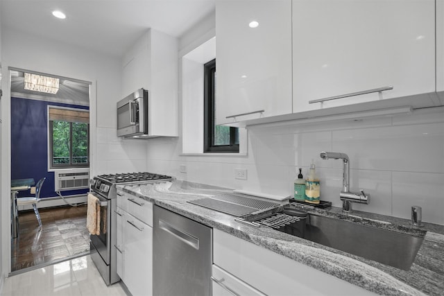 100 E Hartsdale Ave Unit Tfw, Hartsdale, NY 10530 - kitchen featuring appliances with stainless steel finishes, white cabinets, a sink, light stone countertops, and recessed lighting
