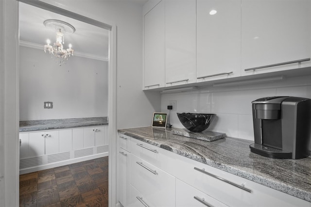 100 E Hartsdale Ave Unit Tfw, Hartsdale, NY 10530 - kitchen with white cabinetry, a chandelier, crown molding, and stone counters