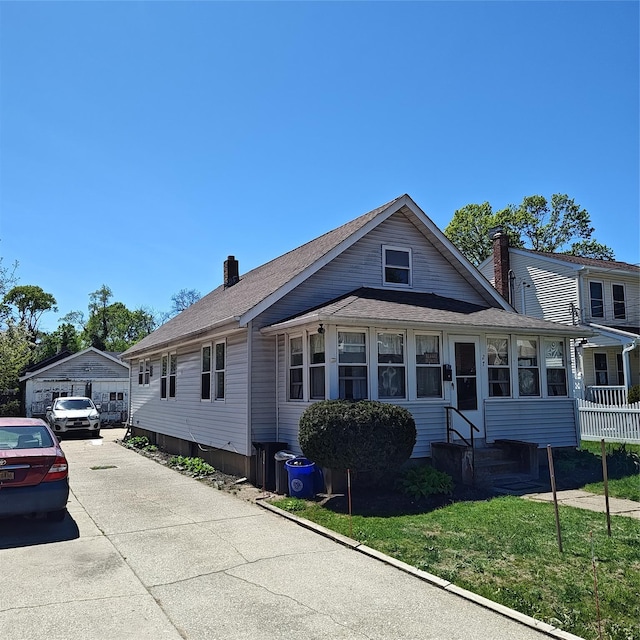 27 Coolidge Ave, Amityville, NY 11701 - bungalow-style home with a chimney and entry steps