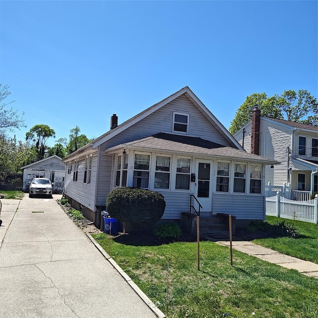 27 Coolidge Ave, Amityville, NY 11701 - view of front of house featuring entry steps, a chimney, and a garage