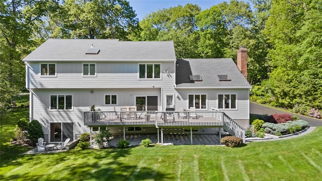 47 Londonderry Ln, Somers, NY 10589 - back of property with a chimney, a wooden deck, a lawn, and a shingled roof