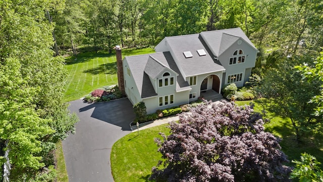 47 Londonderry Ln, Somers, NY 10589 - view of front of property featuring roof with shingles, driveway, a forest view, a front yard, and a chimney