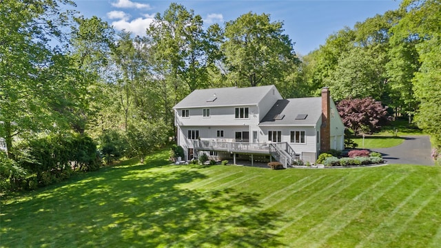 47 Londonderry Ln, Somers, NY 10589 - rear view of house featuring stairway, a deck, a yard, and a chimney