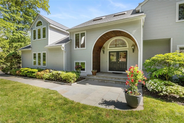 47 Londonderry Ln, Somers, NY 10589 - doorway to property featuring french doors, a shingled roof, and a lawn