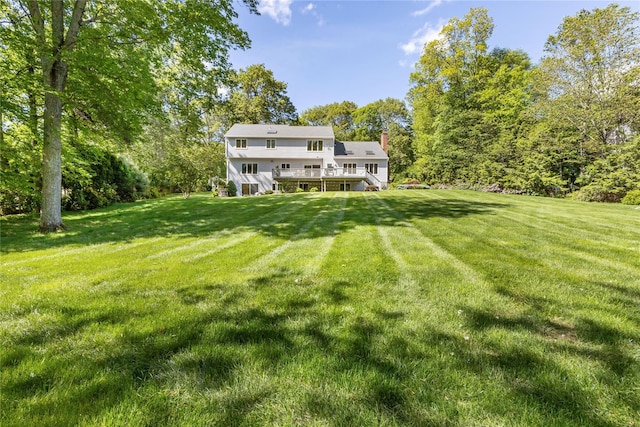 47 Londonderry Ln, Somers, NY 10589 - back of house with stairs, a wooden deck, a yard, and a chimney