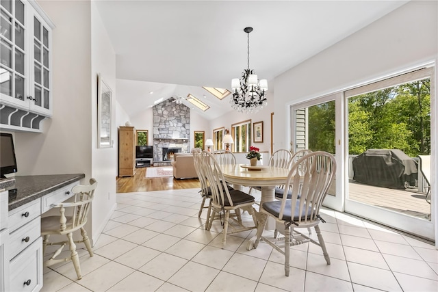 47 Londonderry Ln, Somers, NY 10589 - dining space featuring a stone fireplace, lofted ceiling, a chandelier, light tile patterned flooring, and an office area