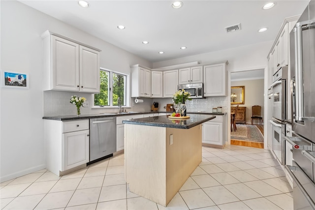 47 Londonderry Ln, Somers, NY 10589 - kitchen with appliances with stainless steel finishes, a sink, a kitchen island, decorative backsplash, and recessed lighting