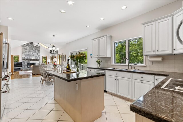 47 Londonderry Ln, Somers, NY 10589 - kitchen with a sink, tasteful backsplash, a stone fireplace, a center island, and recessed lighting