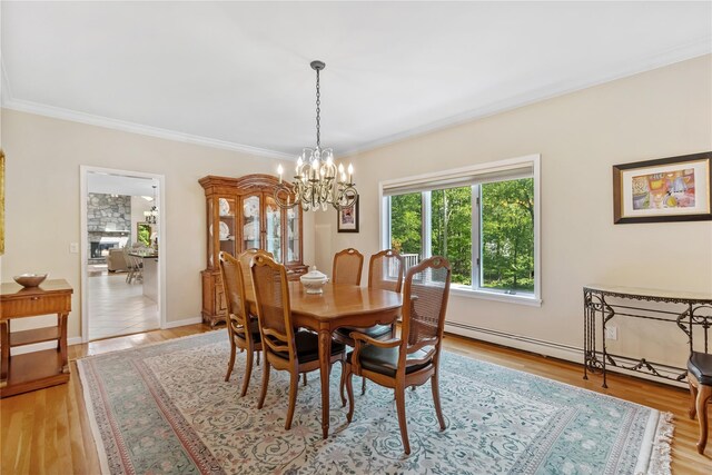 47 Londonderry Ln, Somers, NY 10589 - dining space featuring a chandelier, ornamental molding, light wood-style flooring, a baseboard heating unit, and baseboards