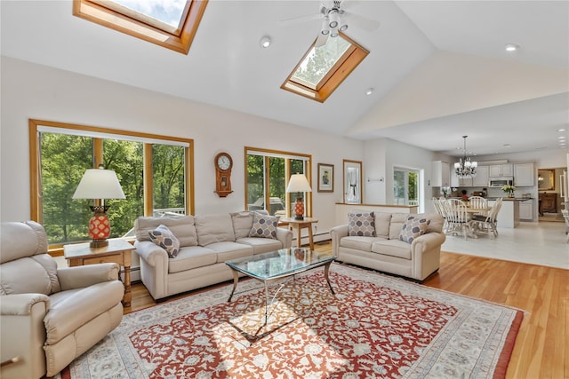 47 Londonderry Ln, Somers, NY 10589 - living area featuring a skylight, light wood-type flooring, a baseboard radiator, high vaulted ceiling, and recessed lighting