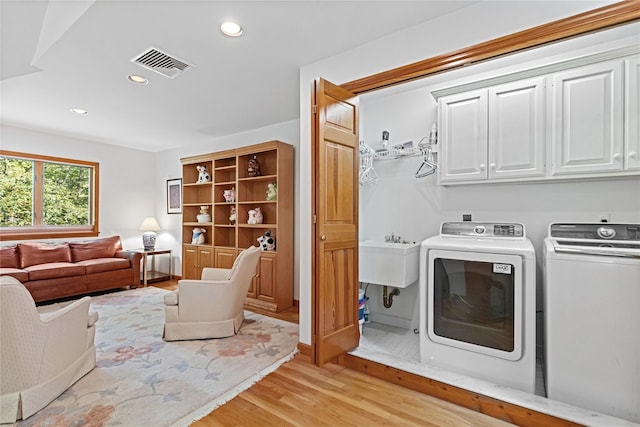 47 Londonderry Ln, Somers, NY 10589 - laundry area with cabinet space, washer and dryer, light wood-style flooring, and recessed lighting