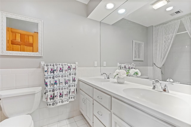 47 Londonderry Ln, Somers, NY 10589 - full bathroom with tile walls, tile patterned flooring, double vanity, toilet, and a wainscoted wall