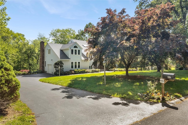47 Londonderry Ln, Somers, NY 10589 - view of front facade featuring driveway, a garage, a front lawn, and a chimney