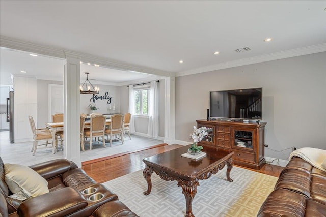 11 Fishermans Dr, Port Washington, NY 11050 - living area with light wood finished floors, a chandelier, recessed lighting, and ornamental molding
