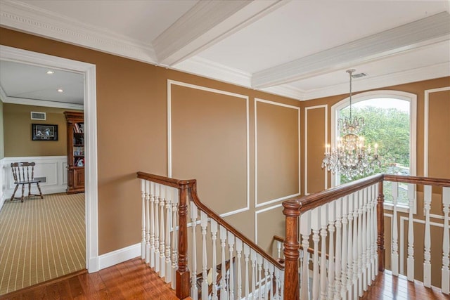 11 Fishermans Dr, Port Washington, NY 11050 - corridor with an upstairs landing, a decorative wall, a chandelier, crown molding, and wood finished floors