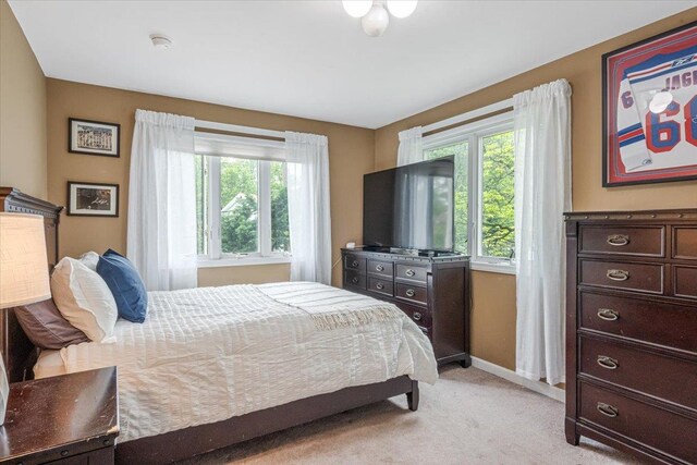 11 Fishermans Dr, Port Washington, NY 11050 - bedroom with light colored carpet and baseboards
