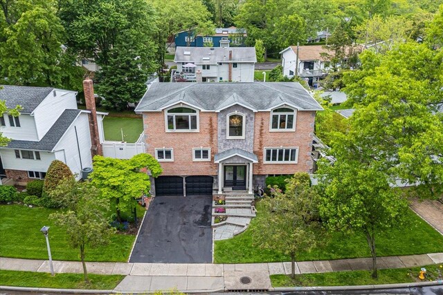 11 Fishermans Dr, Port Washington, NY 11050 - view of front facade featuring driveway, an attached garage, and brick siding