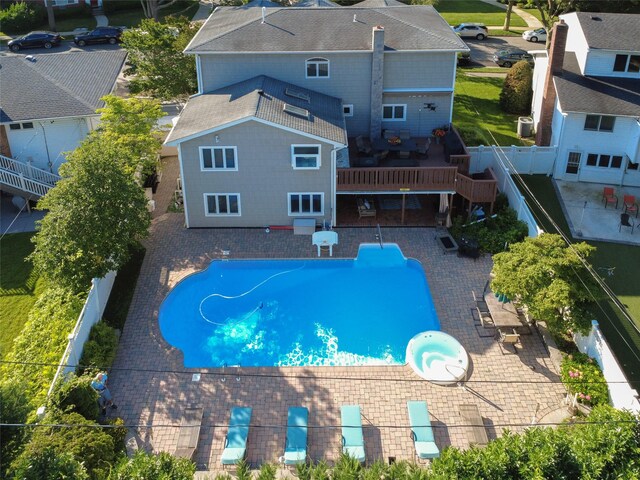 11 Fishermans Dr, Port Washington, NY 11050 - view of swimming pool with a fenced backyard, a pool with connected hot tub, a patio area, and a deck