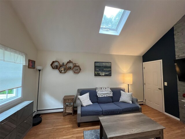 living room featuring lofted ceiling, a skylight, baseboard heating, and light wood-type flooring