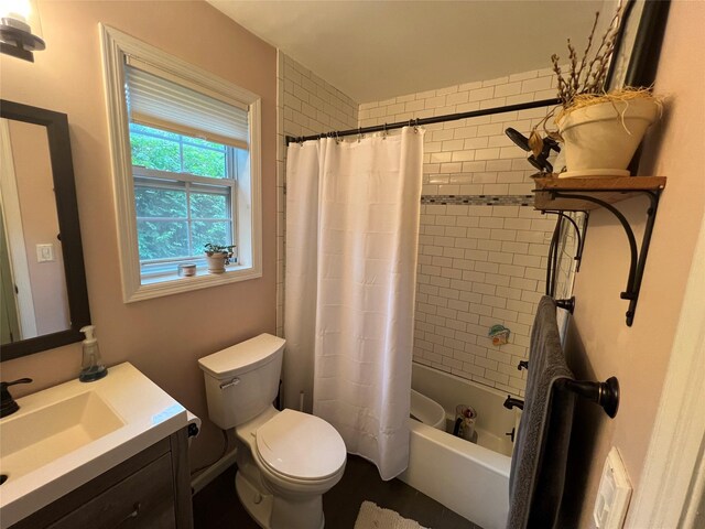 bathroom with toilet, vanity, and shower / bath combo