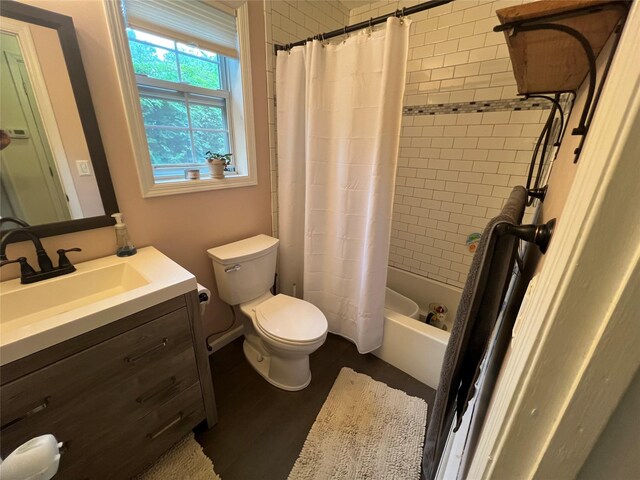 bathroom with toilet, vanity, wood finished floors, and shower / bath combo with shower curtain