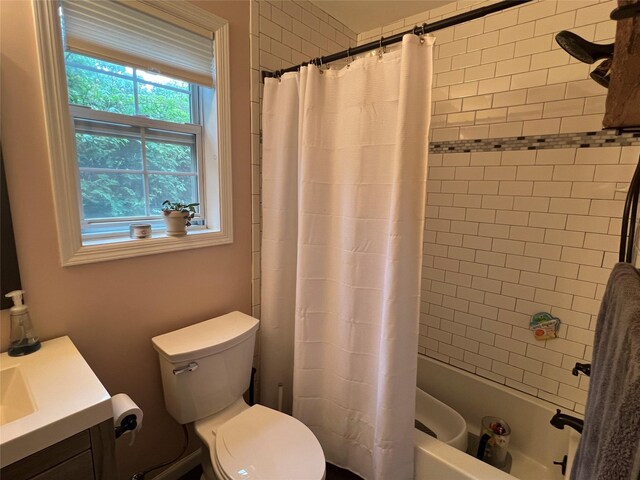 full bath with toilet, vanity, and shower / tub combo