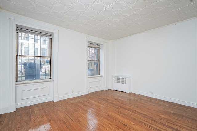 146 Nelson St, Brooklyn, NY 11231 - spare room with radiator, wood finished floors, plenty of natural light, an ornate ceiling, and ornamental molding