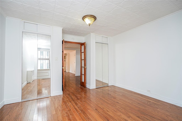 146 Nelson St, Brooklyn, NY 11231 - unfurnished bedroom with hardwood / wood-style flooring, an ornate ceiling, and baseboards