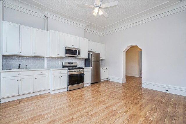 146 Nelson St, Brooklyn, NY 11231 - kitchen with stainless steel appliances, a sink, backsplash, light countertops, and ceiling fan