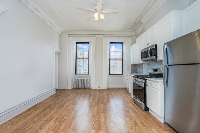 146 Nelson St, Brooklyn, NY 11231 - kitchen featuring stainless steel appliances, radiator, light wood-style floors, light countertops, and ceiling fan