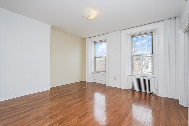 146 Nelson St, Brooklyn, NY 11231 - unfurnished room featuring radiator, wood-type flooring, and baseboards