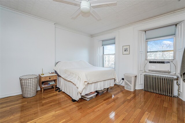 146 Nelson St, Brooklyn, NY 11231 - bedroom featuring radiator, light wood-type flooring, multiple windows, cooling unit, and crown molding