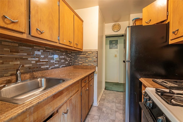 99-35 59th Ave Unit 4K, Corona, NY 11368 - kitchen with white range with gas cooktop, a sink, decorative backsplash, brown cabinets, and light tile patterned floors