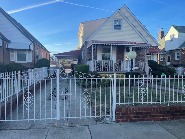 118-52 227th St, Cambria Heights, NY 11411 - bungalow with a fenced front yard, brick siding, a gate, and a porch