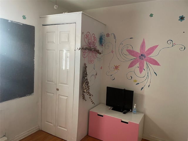 118-52 227th St, Cambria Heights, NY 11411 - unfurnished bedroom with light wood-style floors, baseboards, and a closet