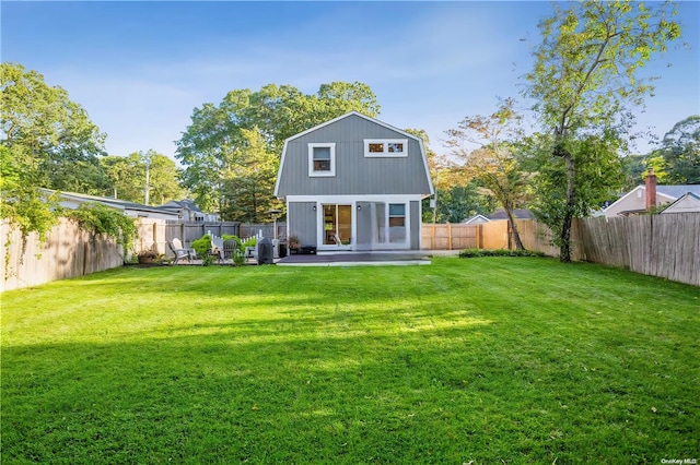 15 Ormond Ave, Selden, NY 11784 - rear view of property featuring a gambrel roof and a patio