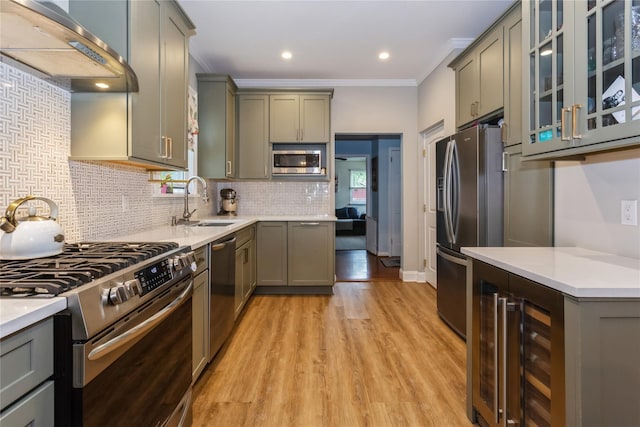 kitchen with stainless steel appliances, extractor fan, a sink, beverage cooler, and gray cabinets