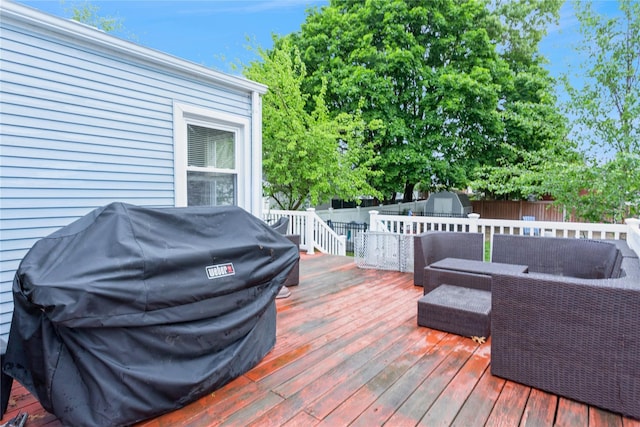 wooden deck featuring a storage shed, a grill, a fenced backyard, and an outdoor structure