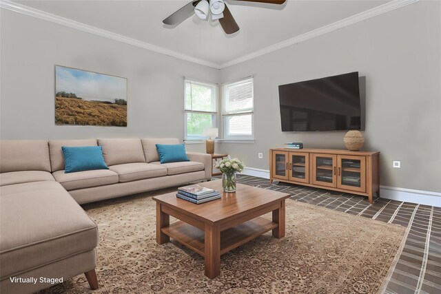 living area featuring baseboards, ornamental molding, and a ceiling fan