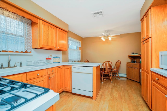 kitchen featuring white appliances, light wood-type flooring, a ceiling fan, and light countertops