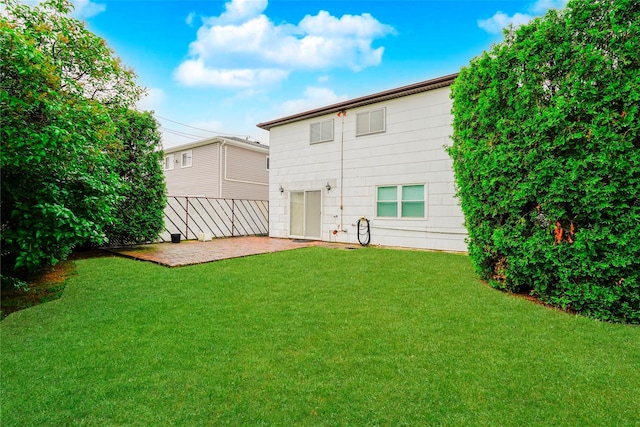 rear view of house with a patio area and a yard