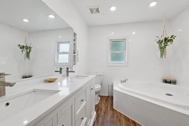 40 Grafton St, Greenlawn, NY 11740 - bathroom featuring toilet, healthy amount of natural light, wood finished floors, a bath, and recessed lighting