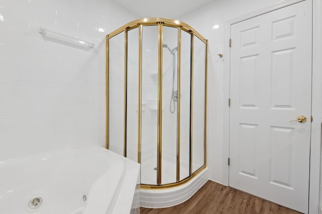 40 Grafton St, Greenlawn, NY 11740 - bathroom view of a stall shower, a tub with jets, and wood finished floors