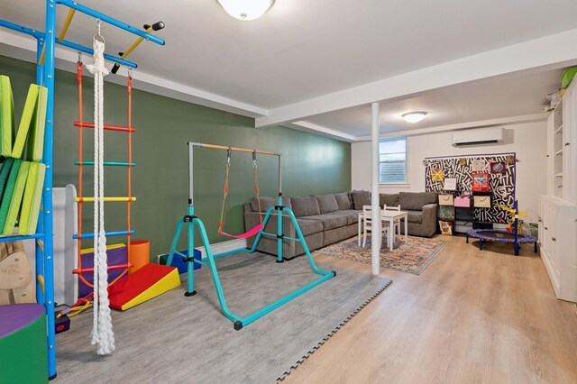 40 Grafton St, Greenlawn, NY 11740 - game room featuring a wall unit AC and wood finished floors