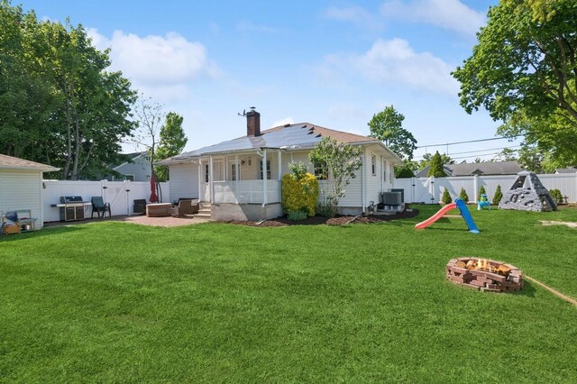 40 Grafton St, Greenlawn, NY 11740 - back of property featuring a fire pit, a patio area, a chimney, central AC, and entry steps