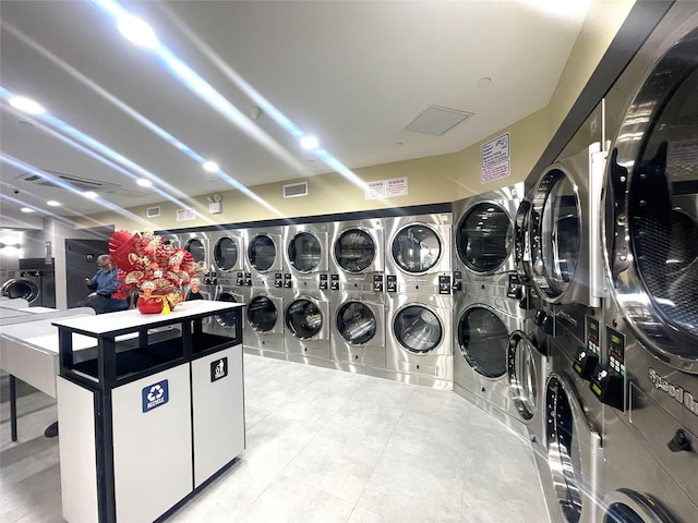 70-26 Queens Blvd Unit 10B, Woodside, NY 11377 - shared laundry room with estacked washer and dryer, washing machine and dryer, and tile patterned flooring