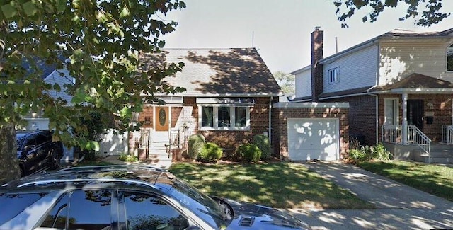 view of front of property featuring brick siding, a garage, driveway, and a front lawn