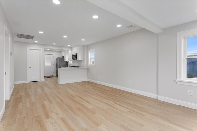 208 W Alhambra Ave, Lindenhurst, NY 11757 - unfurnished living room featuring plenty of natural light, baseboards, light wood finished floors, and recessed lighting