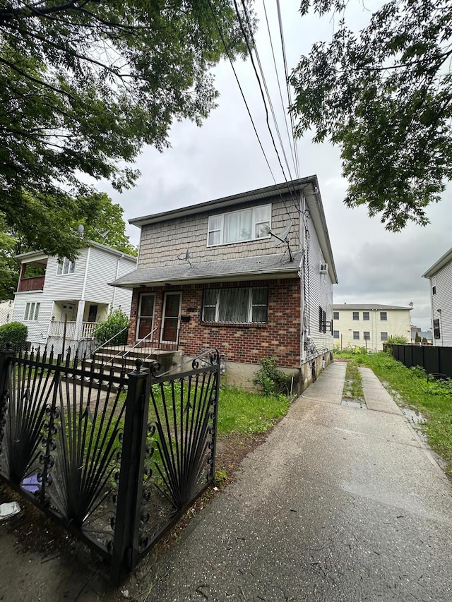 14207 135th Ave, Jamaica, NY 11436 - view of front of house with brick siding and a fenced front yard