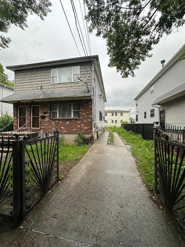 14207 135th Ave, Jamaica, NY 11436 - view of home's exterior with brick siding, fence, and a gate